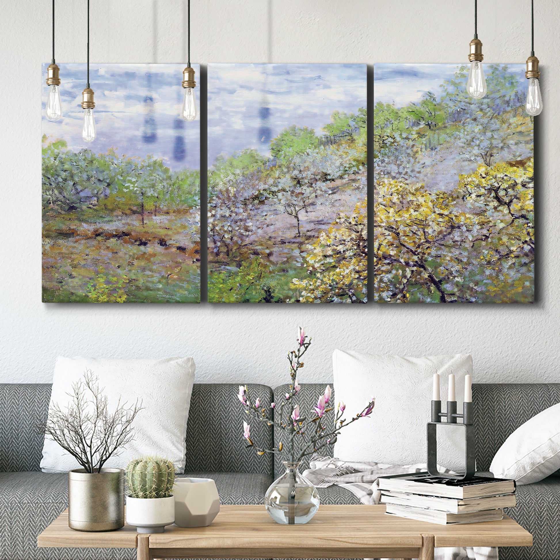 Three-panel canvas wall art featuring spring orchard in full bloom, displayed in a modern living room above seating.