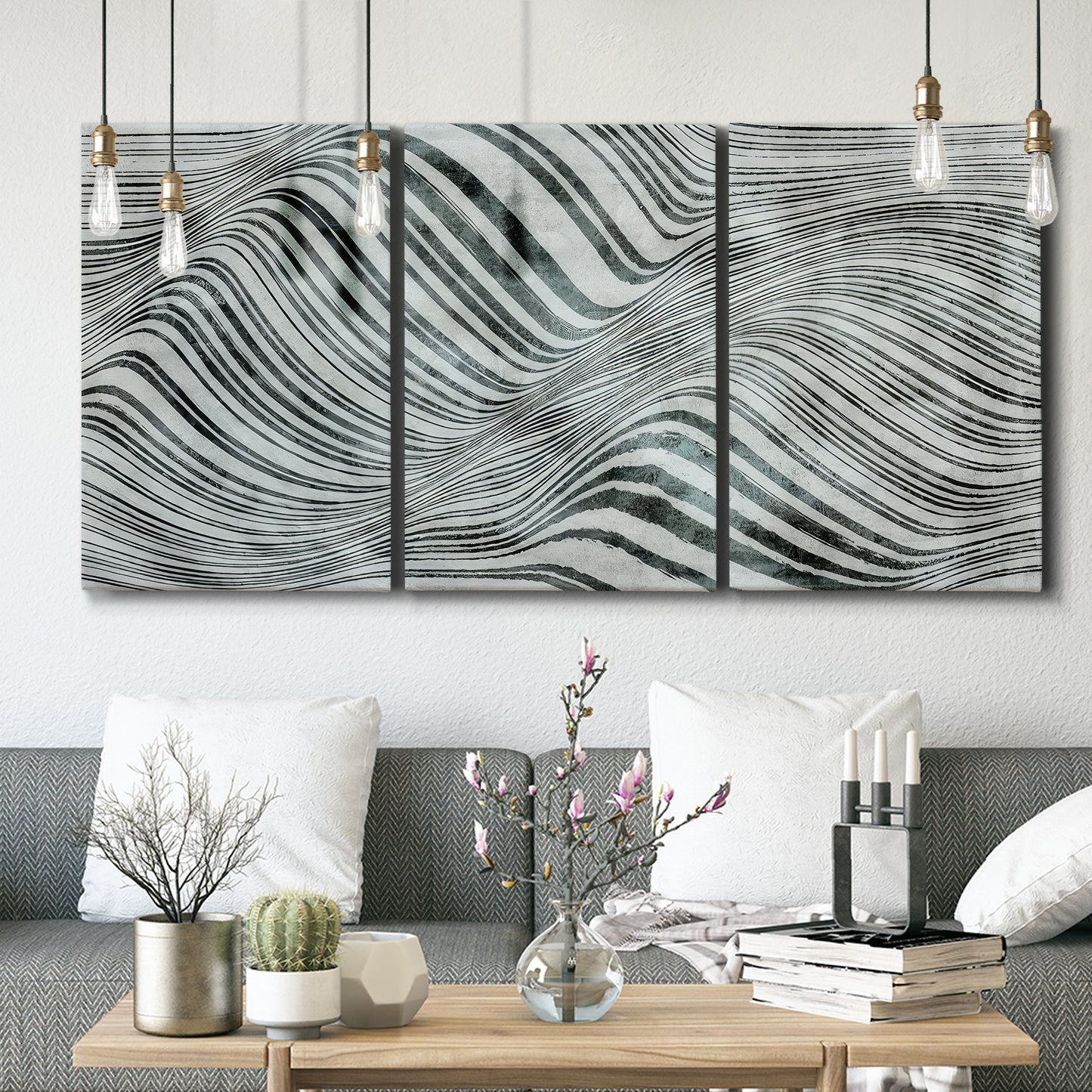 Three-panel canvas wall art featuring coastal shoreline with gentle surf, displayed in a modern living room above seating.