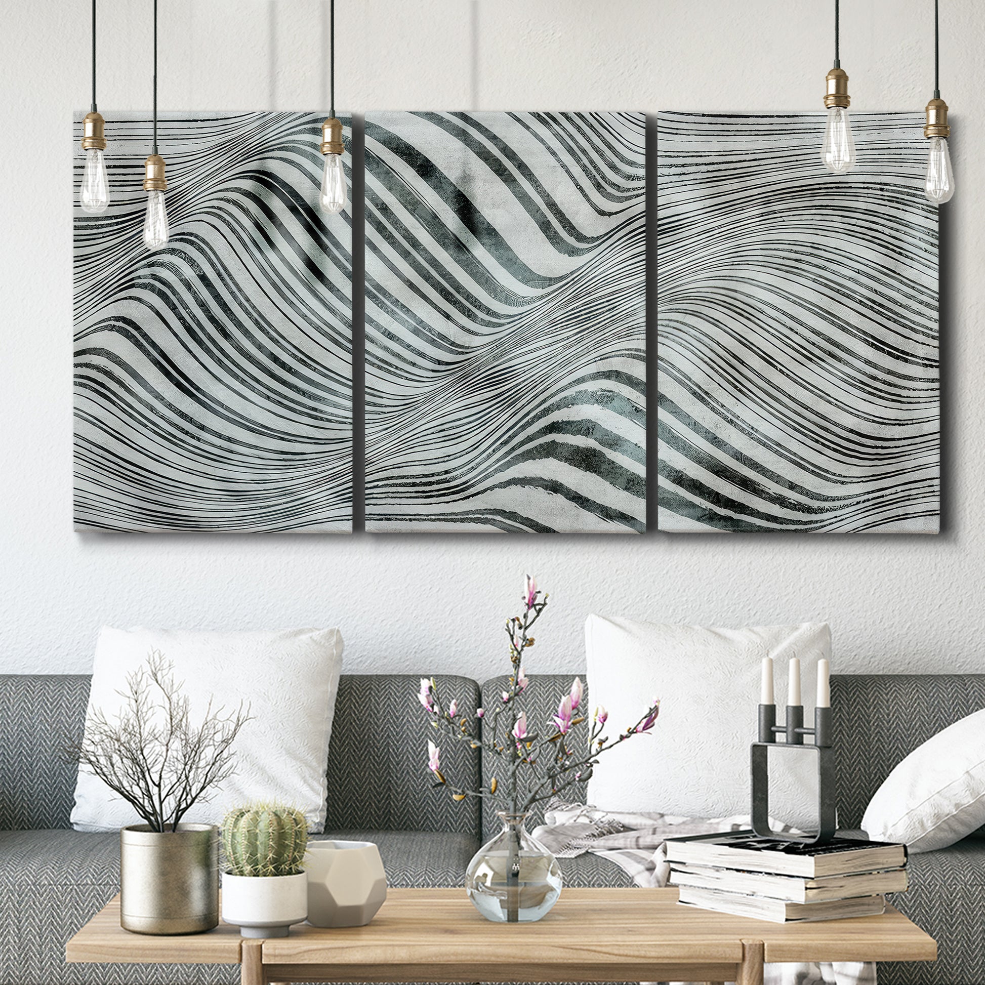 Three-panel canvas wall art featuring coastal shoreline with gentle surf, displayed in a modern living room above seating.