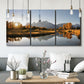 Three-panel canvas wall art featuring river canyon landscape photograph, displayed in a modern living room above seating.