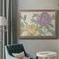 Contemporary peony flower illustration in an ornate traditional silver frame displayed in a neutral interior setting.