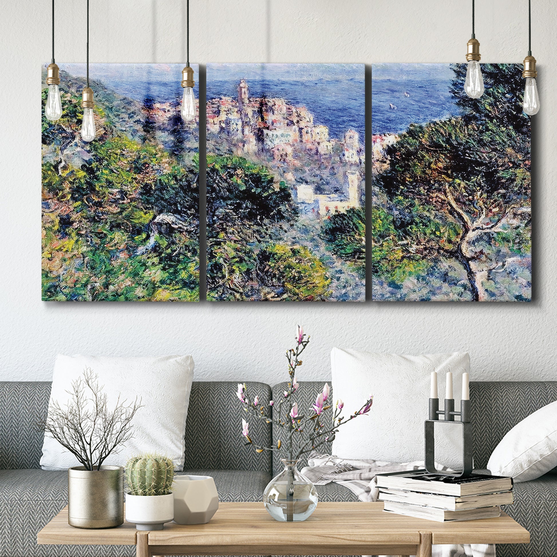 Three-panel canvas wall art featuring coastal hillside overlooking monaco, displayed in a modern living room above seating.