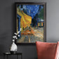 Impressionist night café street scene by Vincent van Gogh in an ornate black frame with gilded inner detail displayed in a dark-toned interior setting.