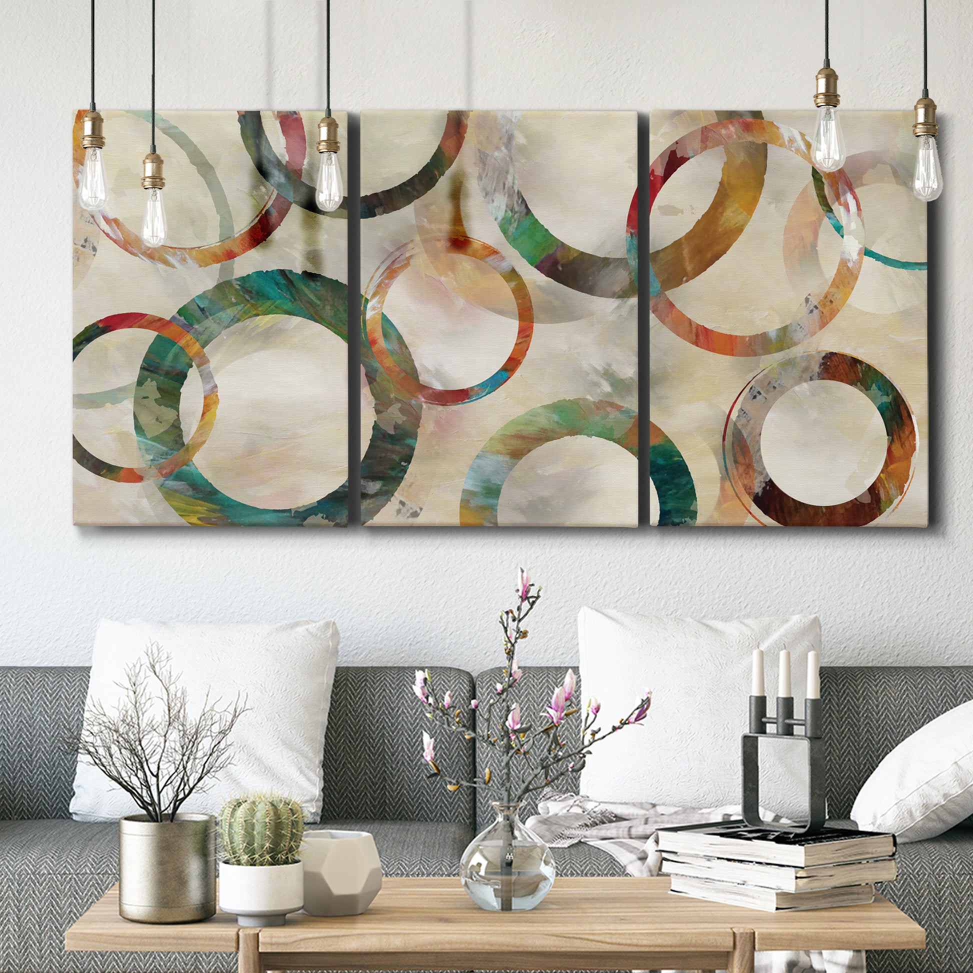 Three-panel canvas wall art featuring geometric circular abstract design, displayed in a modern living room above seating.