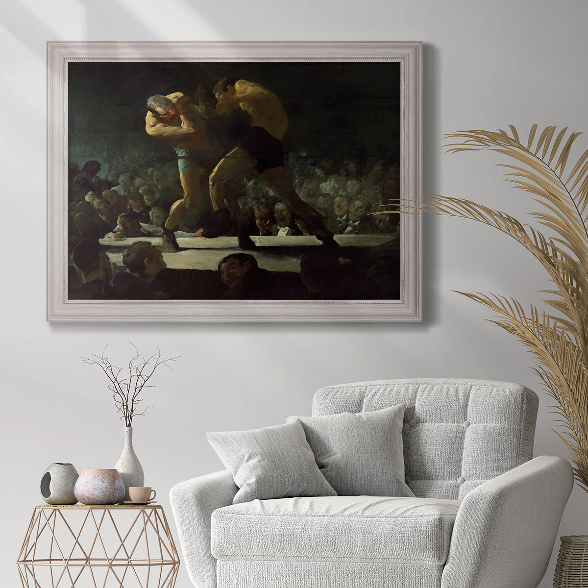 American social club scene painting by George Bellows in an ornate weathered white frame displayed in a bright interior setting.