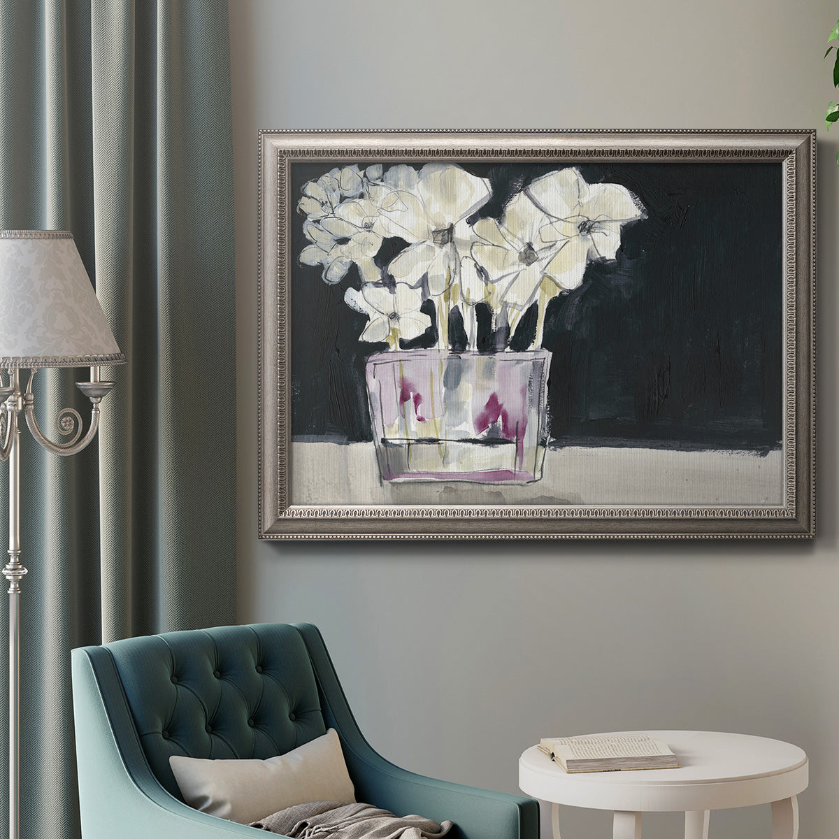 Contemporary floral watercolor with white flowers in an ornate vintage silver frame displayed in a neutral interior setting.