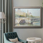 Classical watercolor painting of a French bridge in an ornate vintage silver frame displayed in a neutral interior setting.
