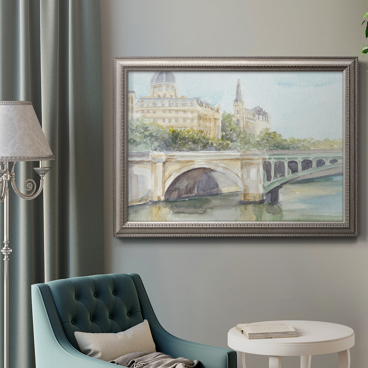 Classical watercolor painting of a French bridge in an ornate vintage silver frame displayed in a neutral interior setting.