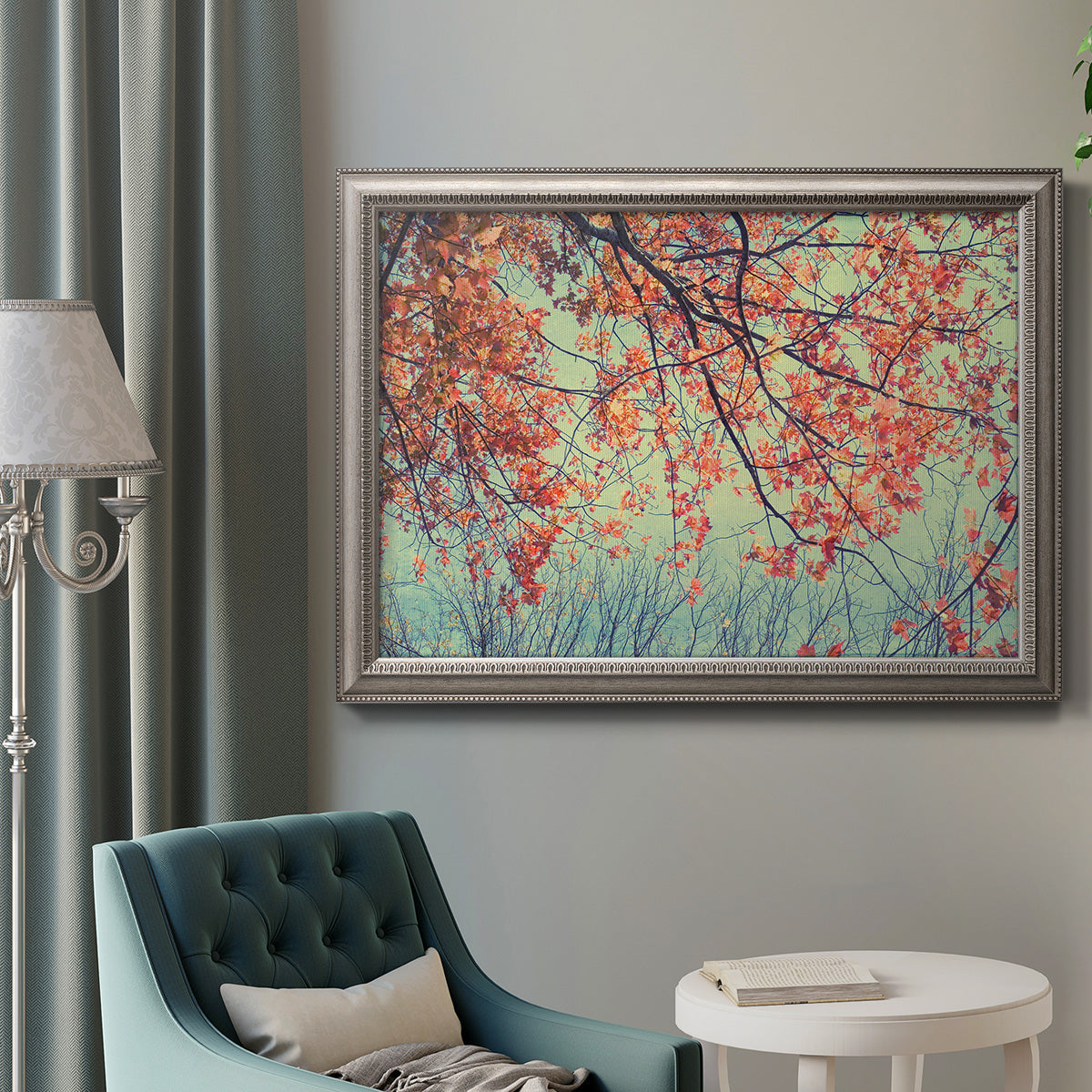 Eclectic fall floral landscape artwork in an ornate vintage silver frame displayed in a neutral interior setting.