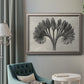 Vintage botanical plant study photograph by Karl Blossfeldt in an ornate vintage silver frame displayed in a neutral interior setting.