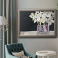 Modern abstract white floral watercolor artwork in an ornate vintage silver frame displayed in a neutral interior setting.
