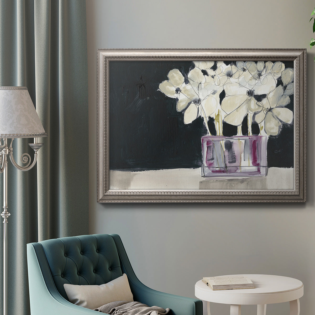 Modern abstract white floral watercolor artwork in an ornate vintage silver frame displayed in a neutral interior setting.