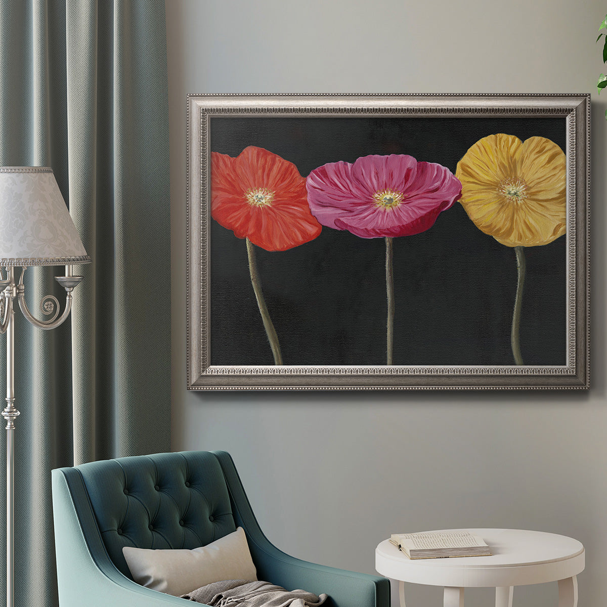Contemporary poppy flower artwork in an ornate vintage silver frame displayed in a neutral interior setting.