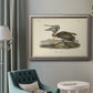 Antique brown pelican bird illustration by John James Audubon in an ornate vintage silver frame displayed in a neutral interior setting.