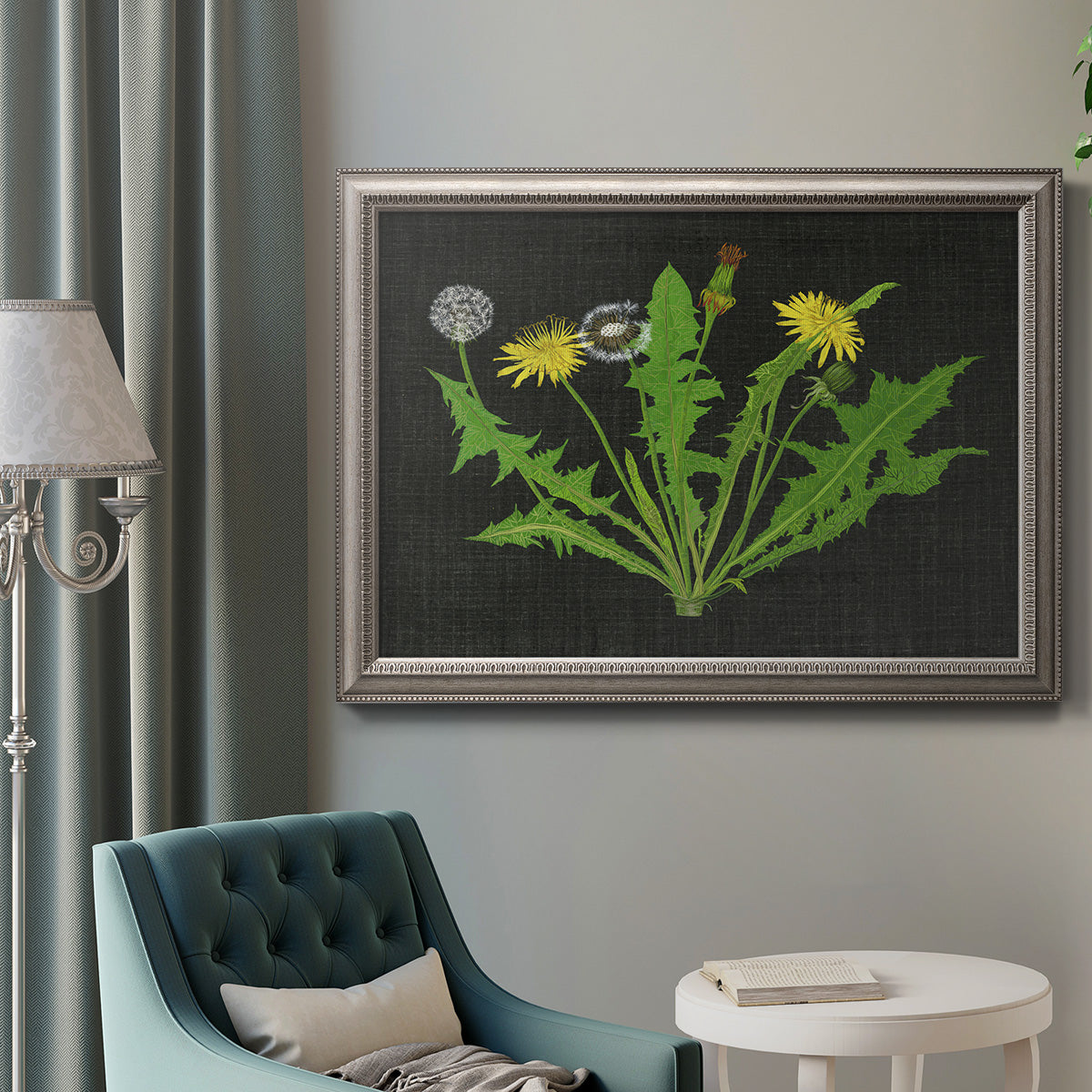 Vintage botanical dandelion flower illustration in an ornate vintage silver frame displayed in a neutral interior setting.