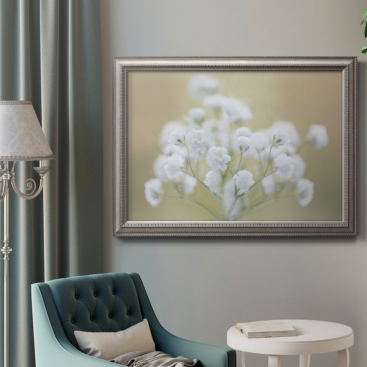 Botanical baby’s breath flower photography in an ornate vintage silver frame displayed in a neutral interior setting.