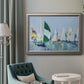 Coastal harbor watercolor painting in an ornate vintage silver frame displayed in a neutral interior setting.
