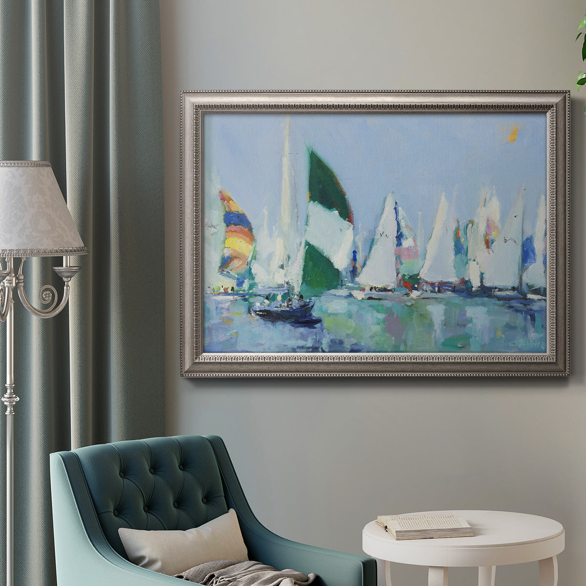 Coastal harbor watercolor painting in an ornate vintage silver frame displayed in a neutral interior setting.