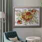 Classic still life painting of apples in an ornate vintage silver frame displayed in a neutral interior setting.