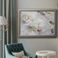 White peonies in bloom in an ornate vintage silver frame displayed in a neutral interior setting.