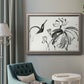 Asian-inspired lotus flower illustration in an ornate vintage silver frame displayed in a neutral interior setting.