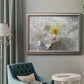 Neutral white peony photography in an ornate vintage silver frame displayed in a neutral interior setting.