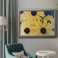 Modern sunflower-style Susan floral photograph in an ornate vintage silver frame displayed in a neutral interior setting.