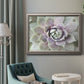 Soft abstract floral botanical photography in an ornate vintage silver frame displayed in a neutral interior setting.