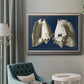 Vintage conch shell illustration on navy background in an ornate vintage silver frame displayed in a neutral interior setting.