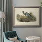 Antique blue heron bird illustration by John James Audubon in an ornate vintage silver frame displayed in a neutral interior setting.
