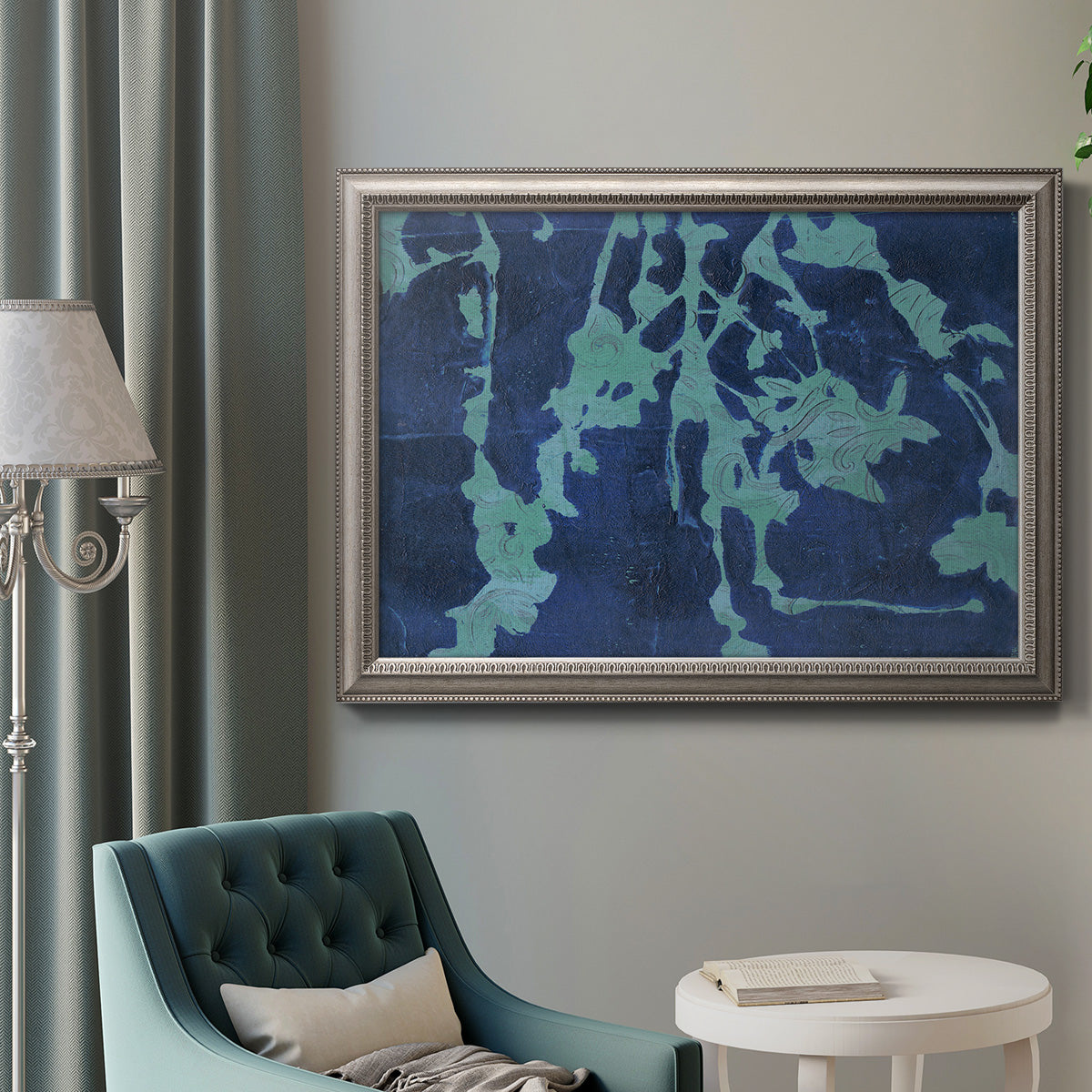 Industrial abstract botanical in an ornate vintage silver frame displayed in a neutral interior setting.