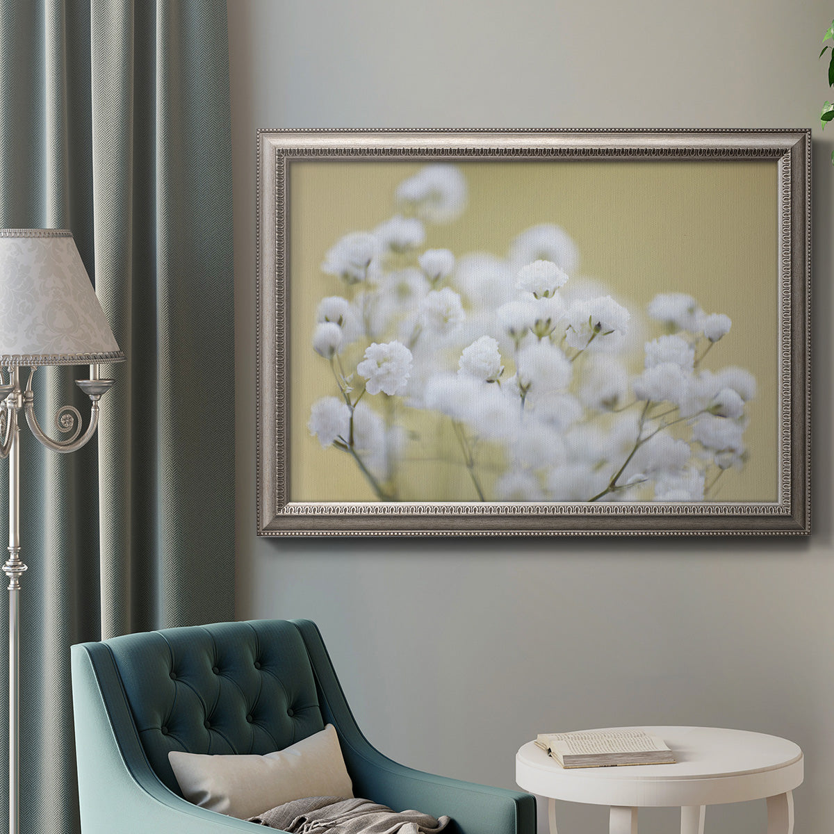 Minimal floral baby’s breath photography in an ornate vintage silver frame displayed in a neutral interior setting.