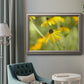 Contemporary black-eyed Susan flower photography in an ornate vintage silver frame displayed in a neutral interior setting.