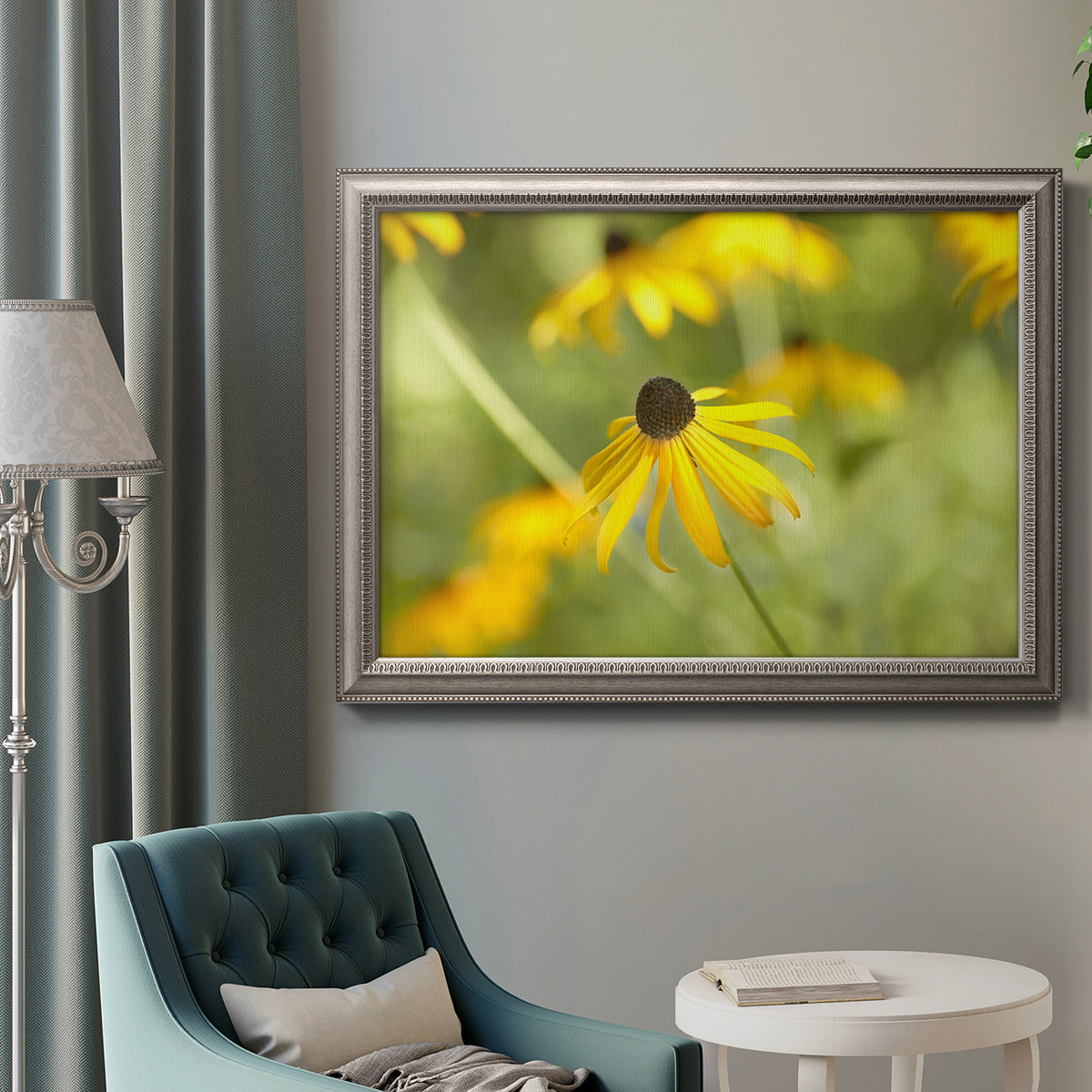 Contemporary black-eyed Susan flower photography in an ornate vintage silver frame displayed in a neutral interior setting.