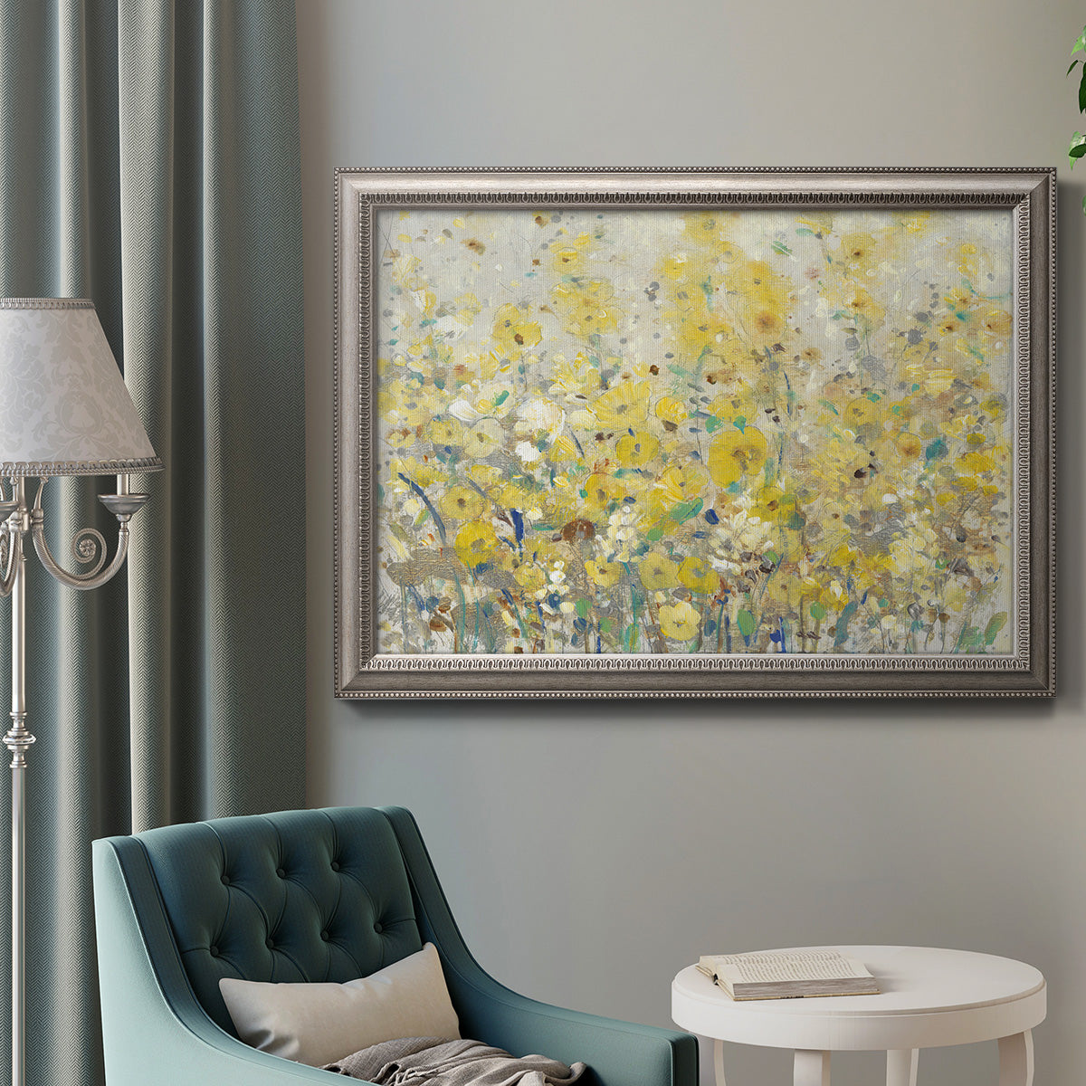 Impressionist floral garden painting in an ornate vintage silver frame displayed in a neutral interior setting.