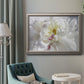 White floral photography close-up in an ornate vintage silver frame displayed in a neutral interior setting.