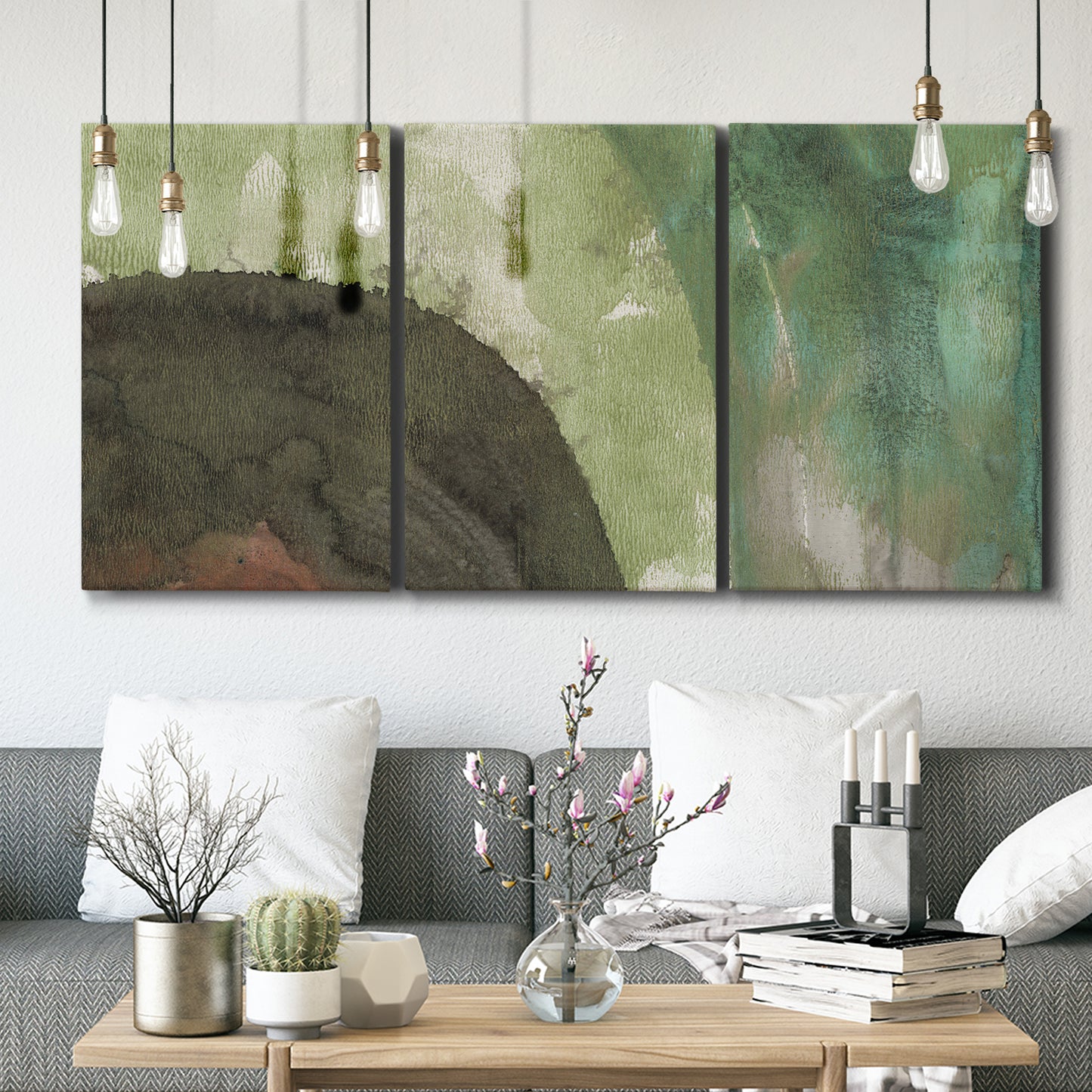 Three-panel canvas wall art featuring layered green abstract composition, displayed in a modern living room above seating.