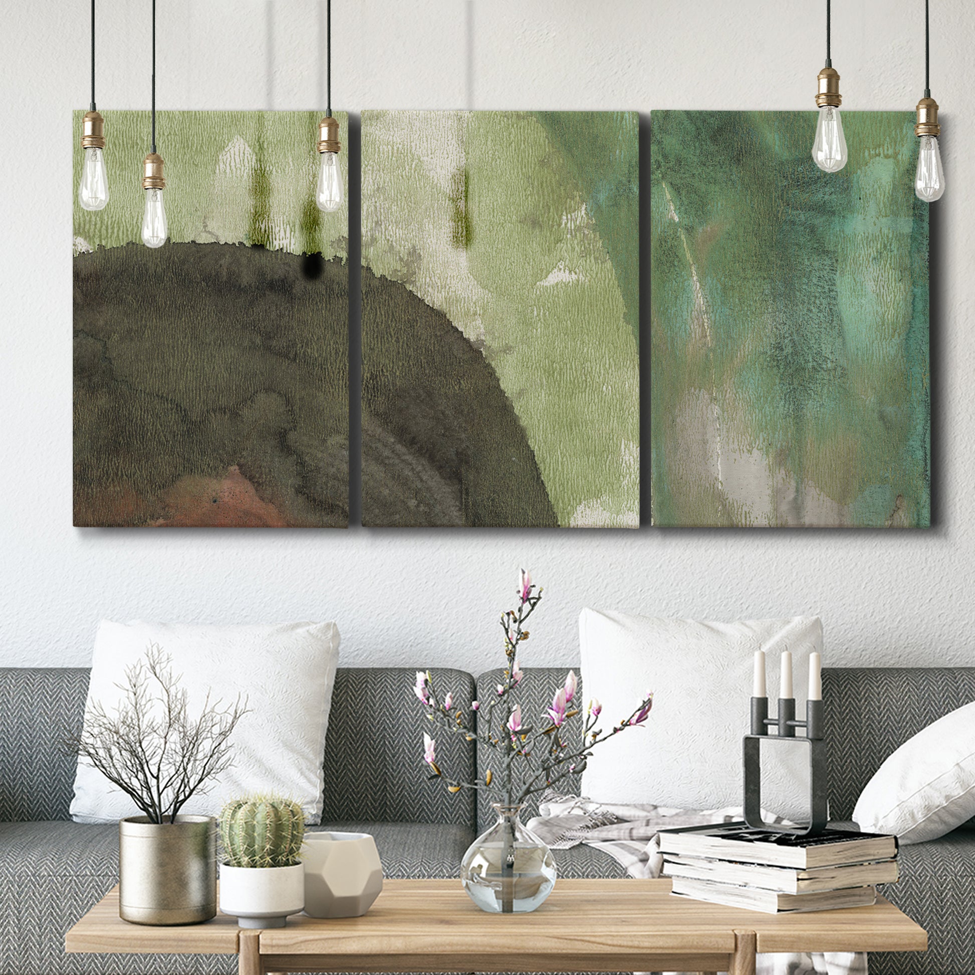 Three-panel canvas wall art featuring layered green abstract composition, displayed in a modern living room above seating.