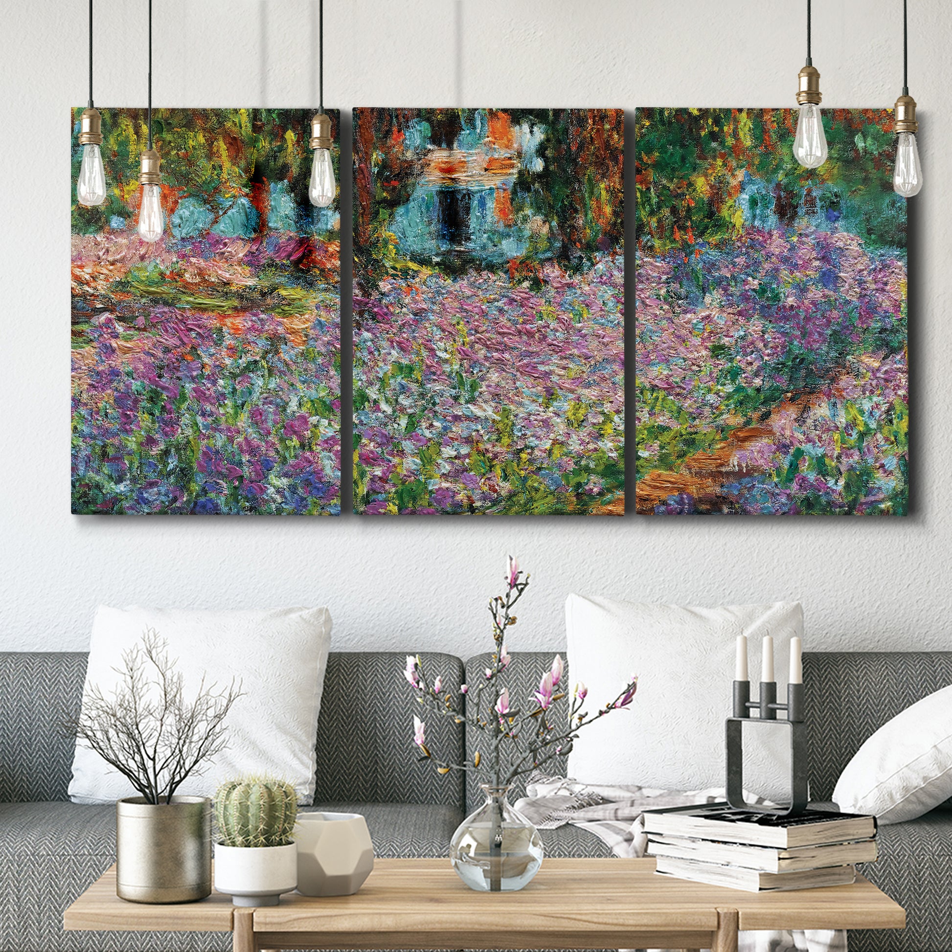 Three-panel canvas wall art featuring blooming irises in garden bed, displayed in a modern living room above seating.