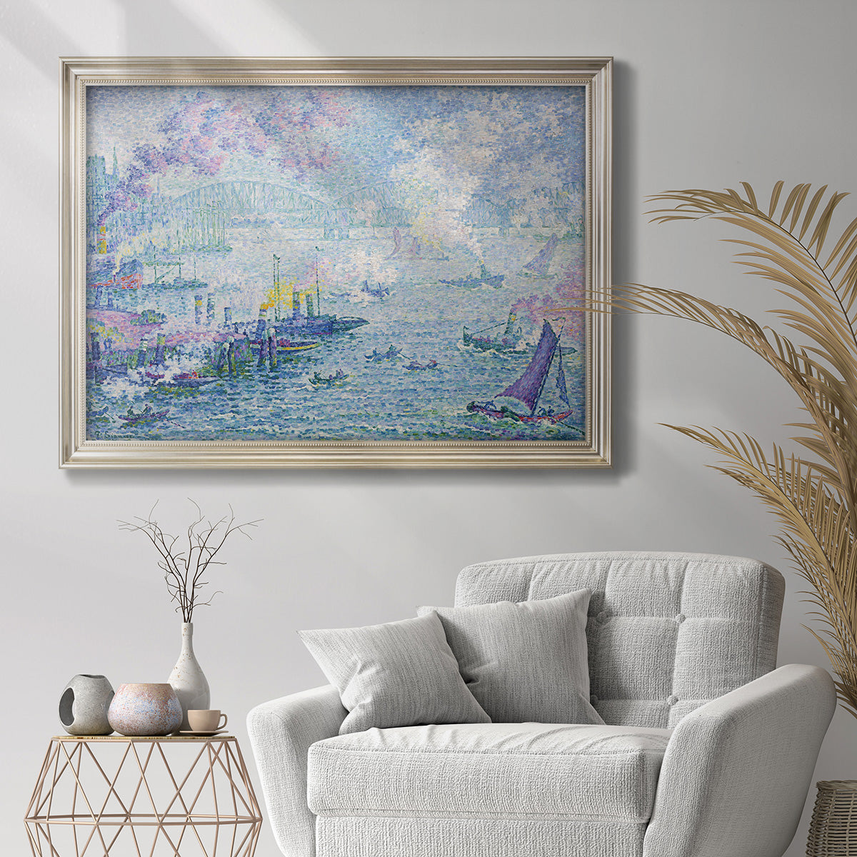 Impressionist industrial harbor scene by Paul Signac in an ornate champagne frame displayed in a bright interior setting.