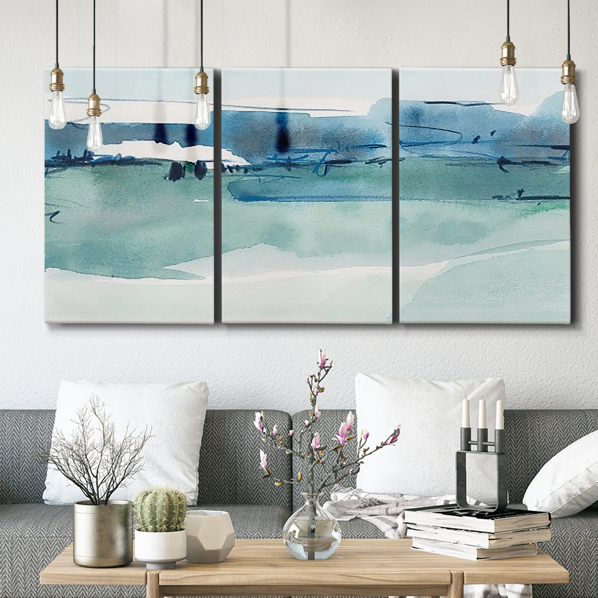 Three-panel canvas wall art featuring minimalist ultramarine abstract vista, displayed in a modern living room above seating.