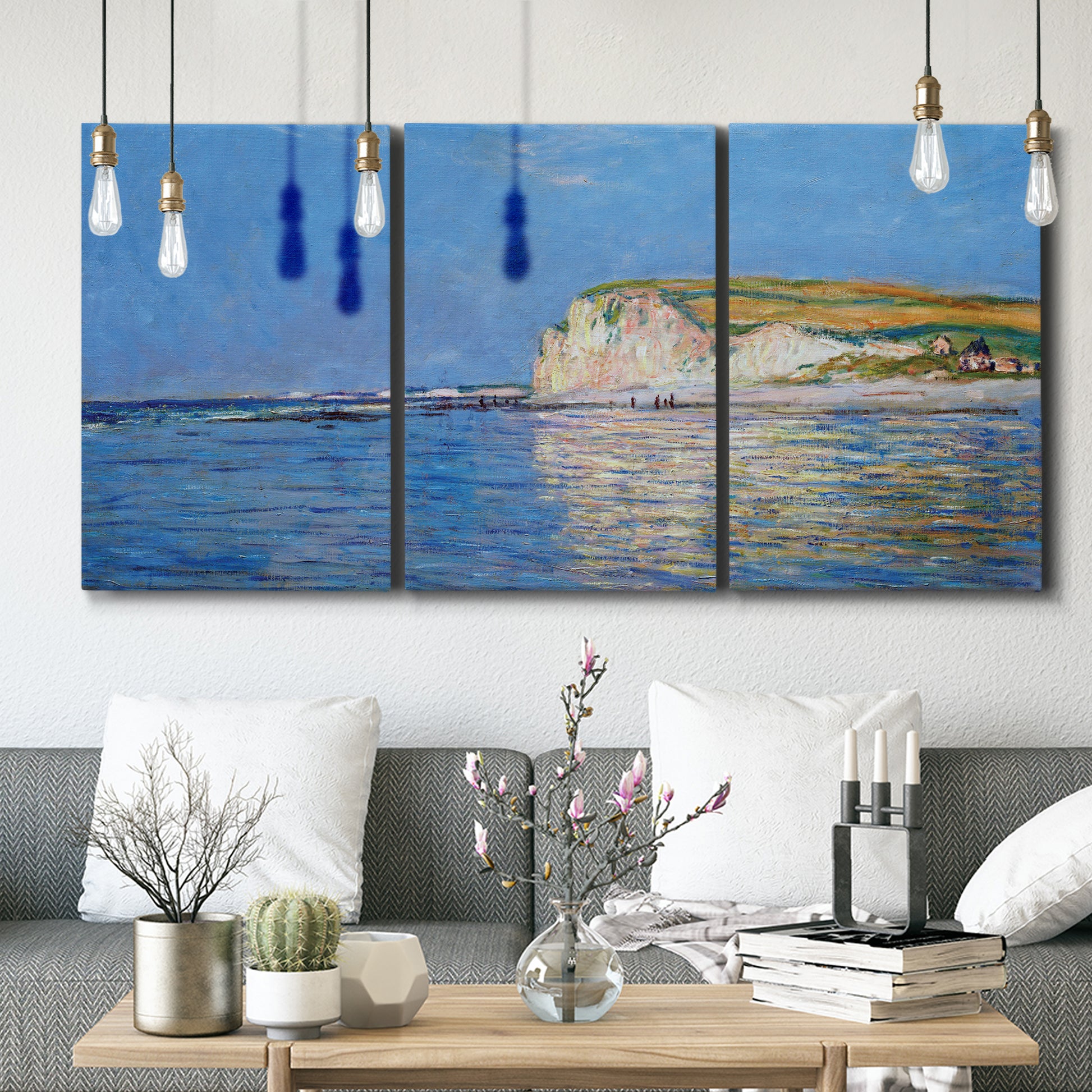 Three-panel canvas wall art featuring white cliffs rising above sea, displayed in a modern living room above seating.
