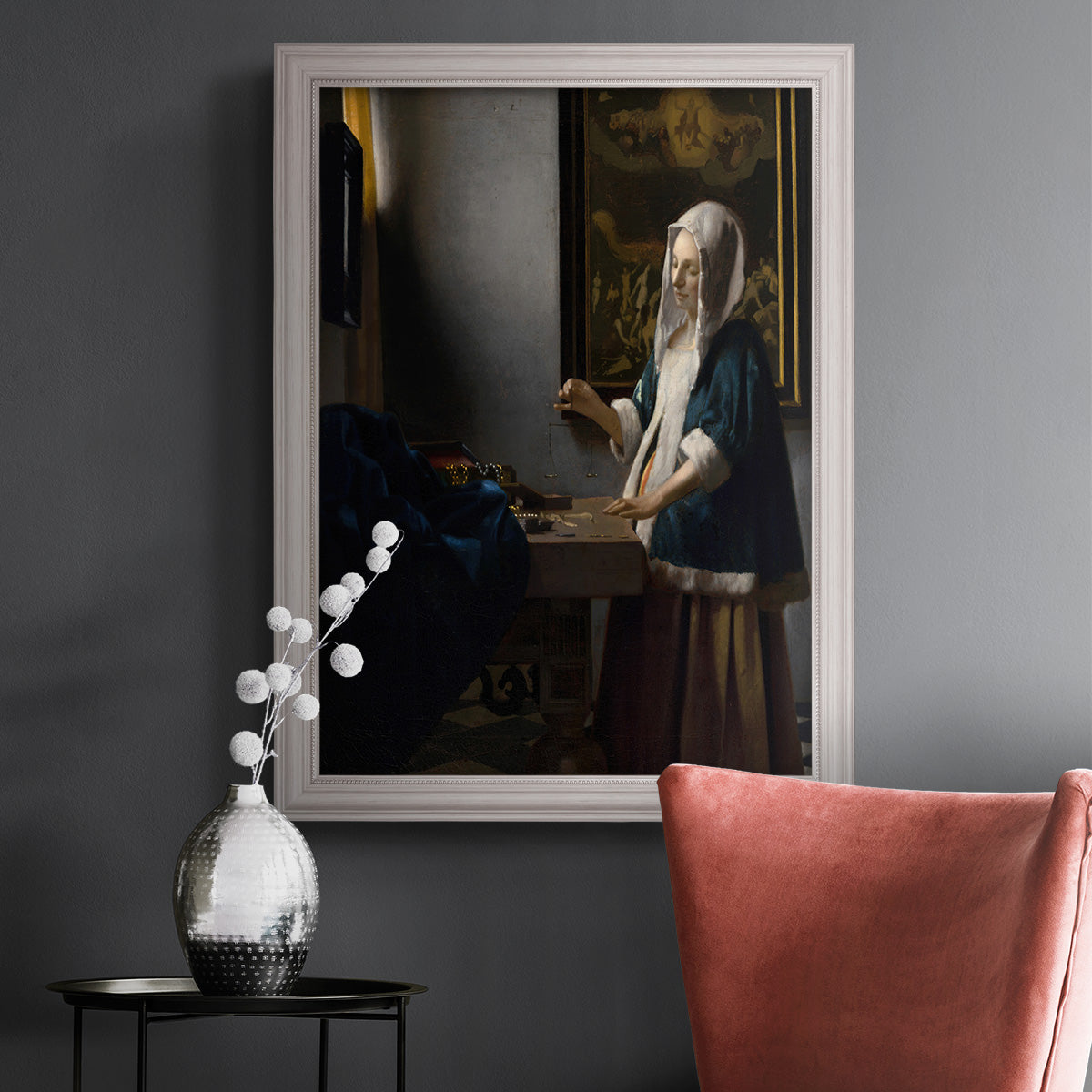 Quiet interior genre scene of a woman with scales by Johannes Vermeer in an ornate weathered white frame displayed in a dark-toned interior setting.