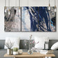 Three-panel canvas wall art featuring layered blue abstract texture, displayed in a modern living room above seating.