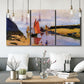 Three-panel canvas wall art featuring stone breakwater at low tide, displayed in a modern living room above seating.