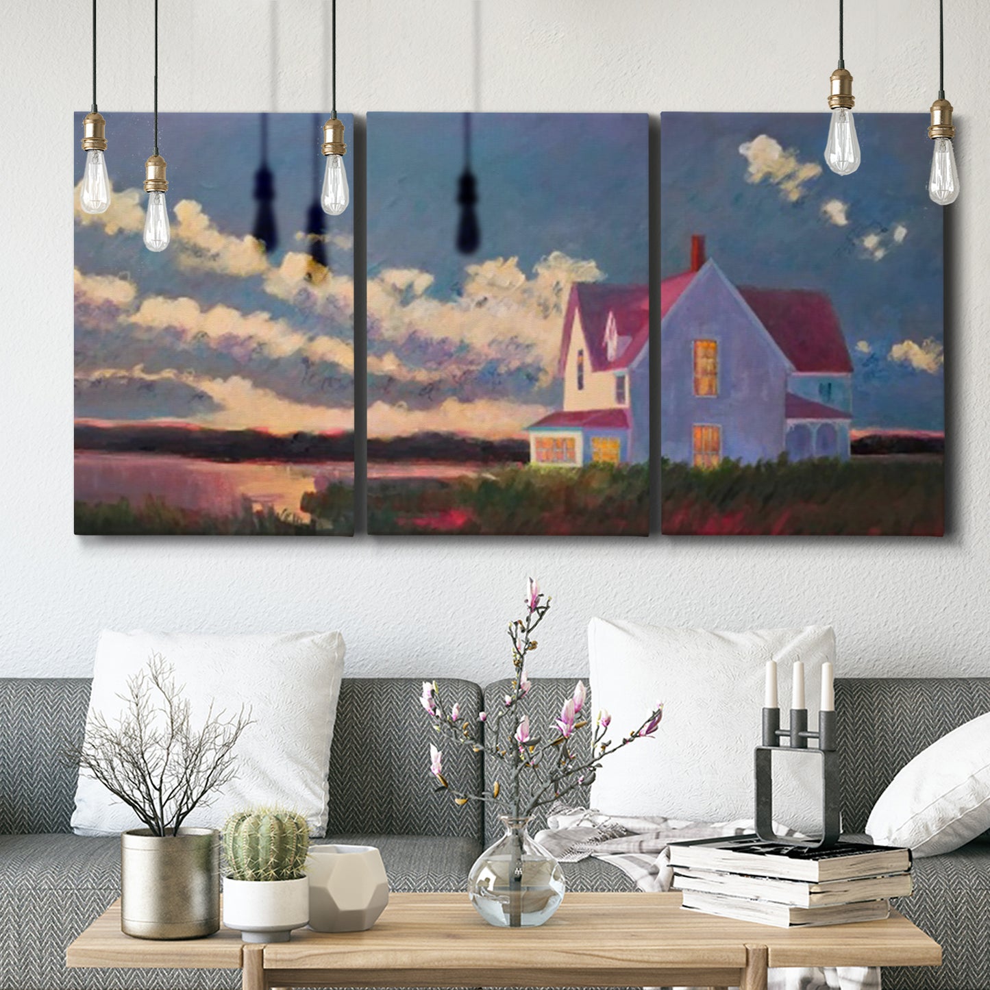 Three-panel canvas wall art featuring farmhouse scene before approaching storm, displayed in a modern living room above seating.