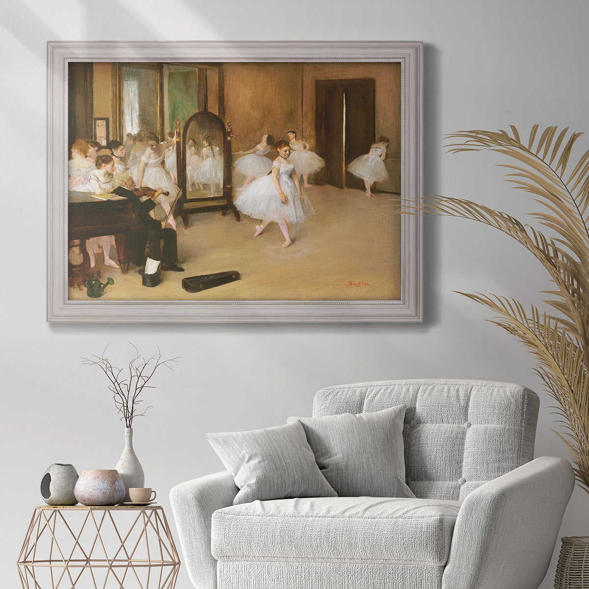 Impressionist dance class interior scene by Edgar Degas in an ornate weathered white frame displayed in a bright interior setting.