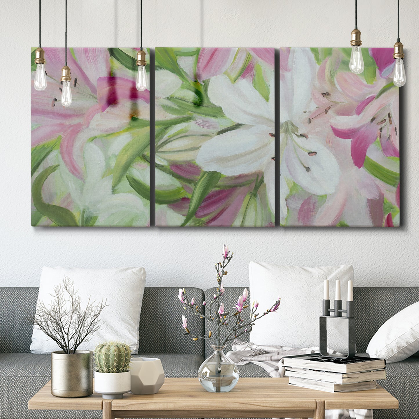 Three-panel canvas wall art featuring pink and white lilies botanical study, displayed in a modern living room above seating.