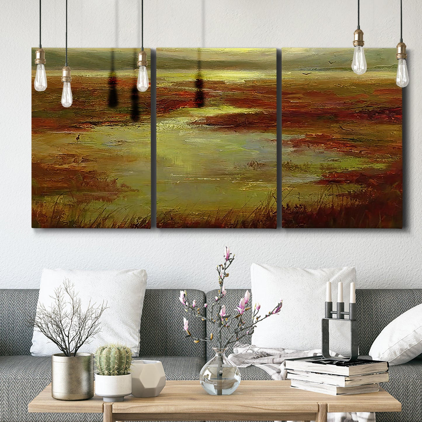 Three-panel canvas wall art featuring coastal shoreline with warm light, displayed in a modern living room above seating.