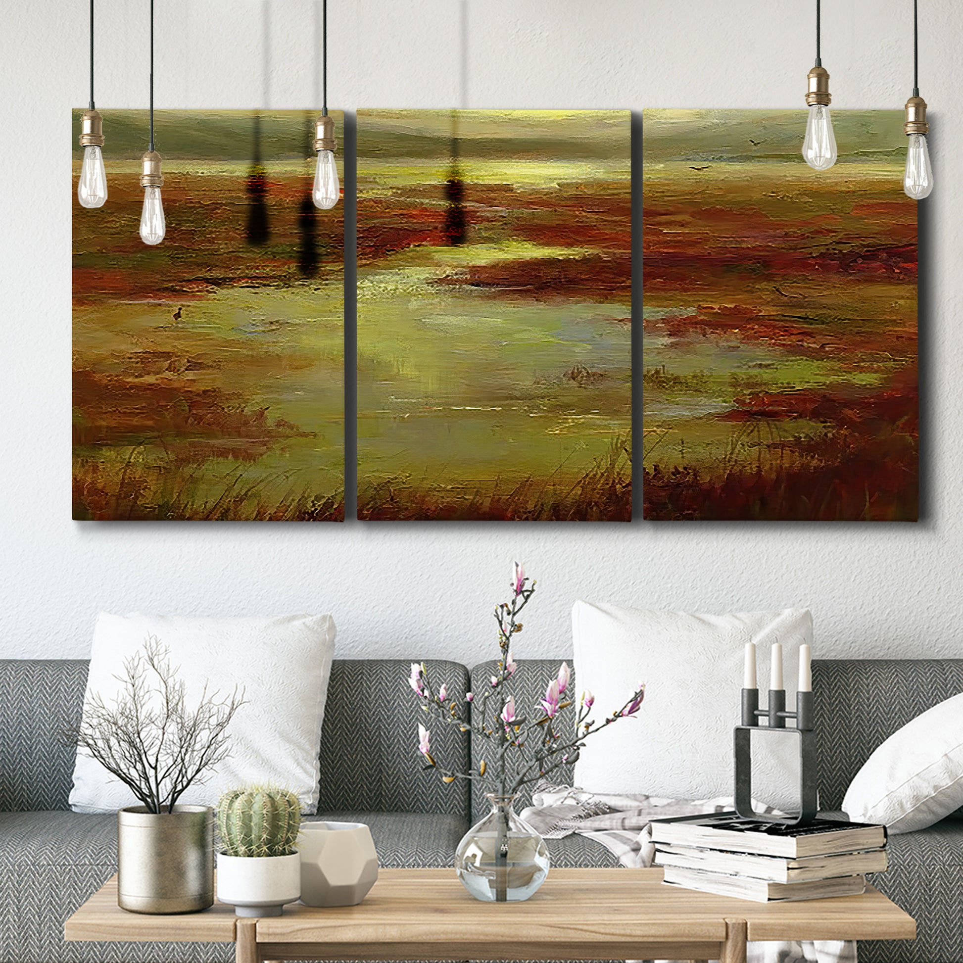 Three-panel canvas wall art featuring coastal shoreline with warm light, displayed in a modern living room above seating.